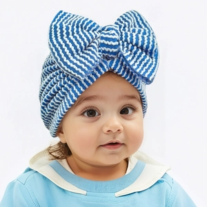Detail of blue and white striped newborn turban hat featuring a large soft bow