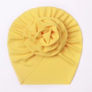 Detail of the yellow ribbed cotton baby turban featuring a large 3D fabric rose flower