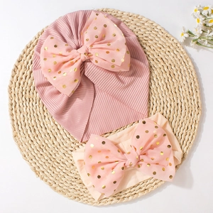 Pink baby turban hat and bow headband set with gold foil polka dots on soft rib knit
