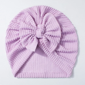 Detailed view of lavender newborn ribbed hat with a large bow showing soft knit texture