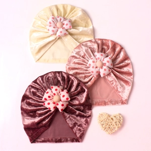 Polka dot flower baby turban hats in gold velvet, three colors displayed in flat lay