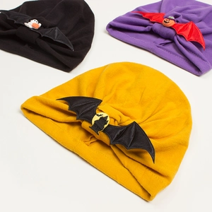 Detail of Halloween baby turban hats with pumpkin, ghost, and bat wing decorations