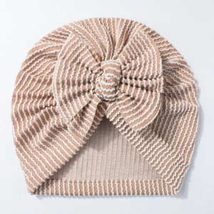 Detailed view of striped newborn turban hat with soft fabric and large bow accessory
