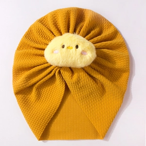Detailed texture of mustard yellow ribbed baby turban hat with cute plush chick ornament