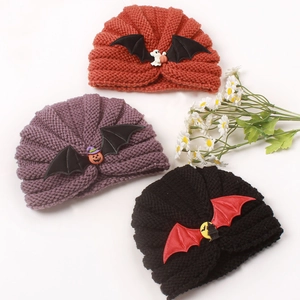 Detailed view of Halloween knit baby hats with bat wings in orange, purple and black