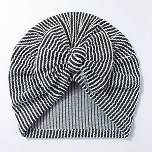 Macro view of newborn striped baby turban showing fabric texture and a large bow tie
