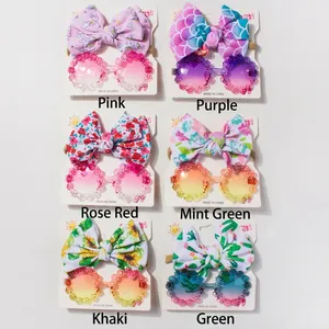 Detailed set of baby sunglasses and matching bow headbands in six vibrant floral patterns