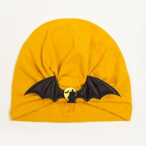 Detail showing ginger yellow baby Halloween hat with black bat wings and castle motif