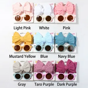 Nine-color set of baby headbands with matching round sunglasses in a 3x3 grid display