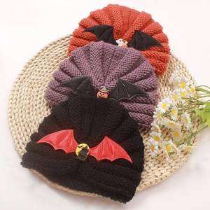 Detailed knit texture and Halloween pumpkin bat decorations on cozy baby winter beanies