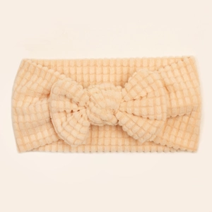 Close-up of baby headband fabric showing soft pineapple texture and big bow detail