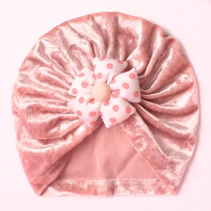 Pink velvet baby beanie with handmade polka dot flower detail for warmth and soft comfort
