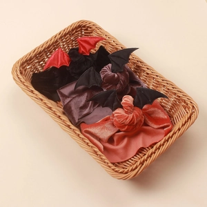 Detailed view of Halloween baby headbands with velvet bat wings in festive colors