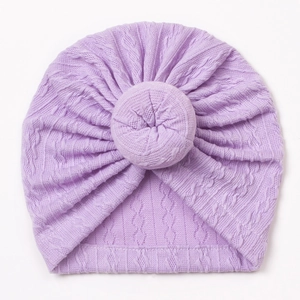 Macro detail of lavender knit baby turban with donut knot and decorative cable texture