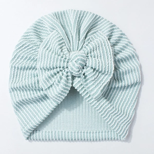 Detailed view of mint green striped newborn hat featuring a large soft knit bow