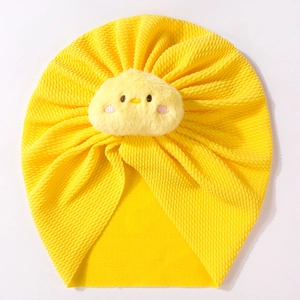 Detailed view of yellow baby turban hat with cute plush chick decor and waffle texture