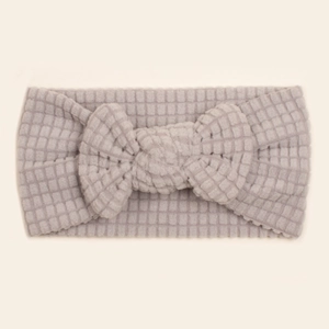 Close-up of light grey baby headband with textured bubble waffle fabric and large bow