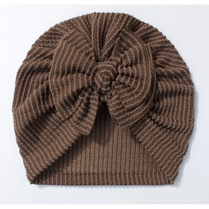Detailed view of chocolate brown ribbed baby turban hat with a large decorative bow