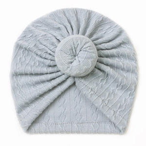 Close-up detail of soft light blue baby turban hat with donut knot and ribbed texture