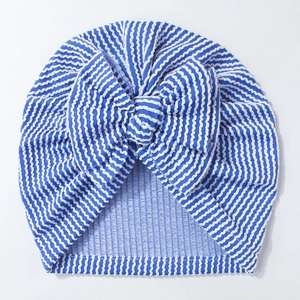 Close-up of baby beanie with blue and white stripes featuring a large soft bow detail
