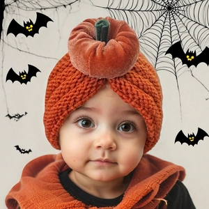 Close-up of baby Halloween pumpkin knit hat with velvet stem and soft orange texture