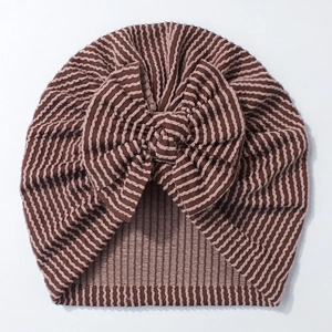 Detailed close-up of brown and beige striped newborn beanie with large bow knot