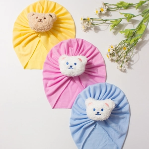 Three-piece infant knit turban hats with plush bear accents in yellow, pink and light blue