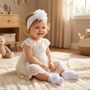 Baby girl white lace dress set with 3D flower headband and matching socks in warm interior