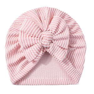 Pink and white striped newborn baby beanie with a large decorative bow tie