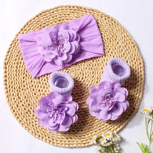 Detail of light purple baby headband and knit socks set with 3D fabric flowers