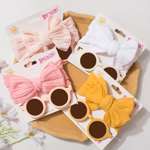 Kids' fashion set featuring bow headbands and round sunglasses in various bright colors