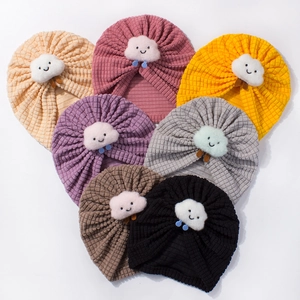 Set of 7 colorful waffle knit baby hats with cute smiling cloud patches for infants