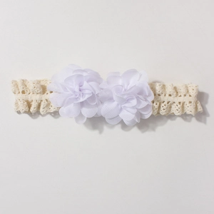 Detail of the layered white chiffon flowers and elastic lace headband for babies