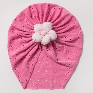 Close-up of hollow embroidery and 3D fabric flower on baby turban hat