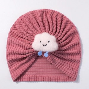 Detail of pink knitted baby turban hat with plush white cloud and blue raindrops