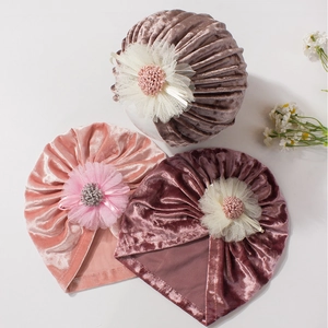 Three velvet baby turban beanies with large mesh flowers in pink and purple shades