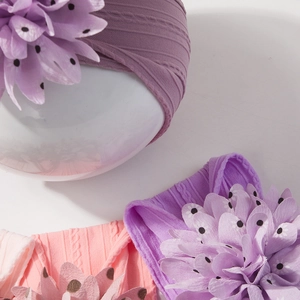 Detail of baby jacquard nylon headbands featuring large polka dot layered fabric flowers