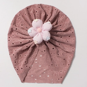 Close-up of baby beanie with 3D fabric flower and breathable hollow-out knit texture