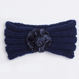 Detail of navy knit baby headband showing the textured weave and handmade satin flower