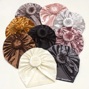 Winter velvet baby donut beanies in various colors with a stylish top knot design