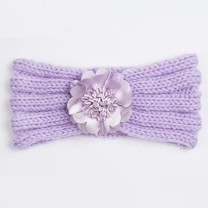 Detail showing lavender cable knit baby headband with a large decorative satin flower