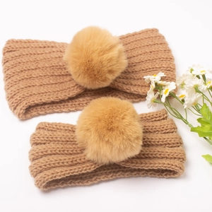 Matching set of two knit headbands with faux fur pom-poms in caramel brown color