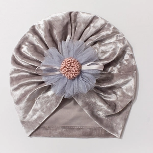 Detailed texture of baby velvet turban hat with cute layered mesh flower and bow accent