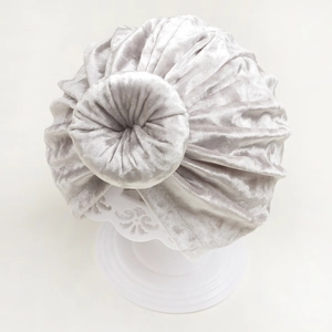 Detail of silver velvet baby turban hat with stylish doughnut bun and pleated texture