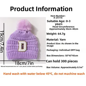 Detail view of purple baby knit hat with pom-pom and D patch for infants aged 0-3 years