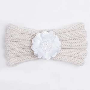 Close-up of off-white knitted baby headband featuring a delicate white floral decoration