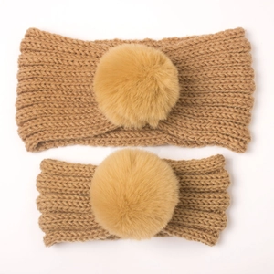 Close-up of khaki knit headband set for parent and child with fluffy faux fur pompom decor