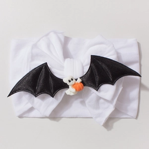Detail of baby Halloween headband with black bat wings and a cute ghost holding a pumpkin