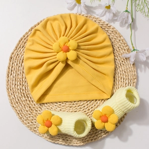 Cute infant baby hat and socks set with yellow sunflower decorations for autumn and winter