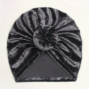 Detail of soft dark grey velvet baby turban hat with central donut knot and pleated texture
